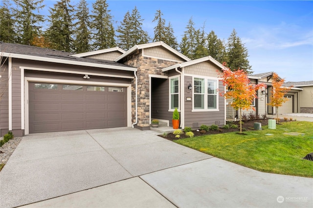 view of front of home with a garage and a front lawn