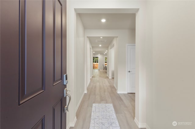 corridor with light wood-type flooring