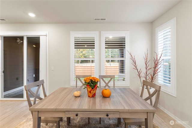 dining space featuring light hardwood / wood-style floors and a healthy amount of sunlight