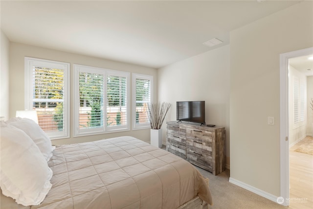 carpeted bedroom with multiple windows