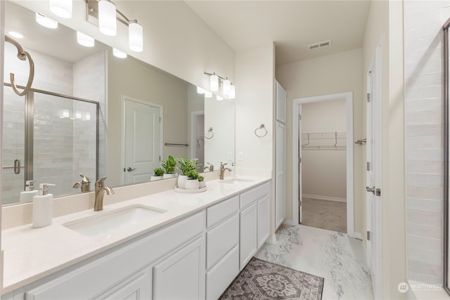 bathroom with walk in shower and vanity