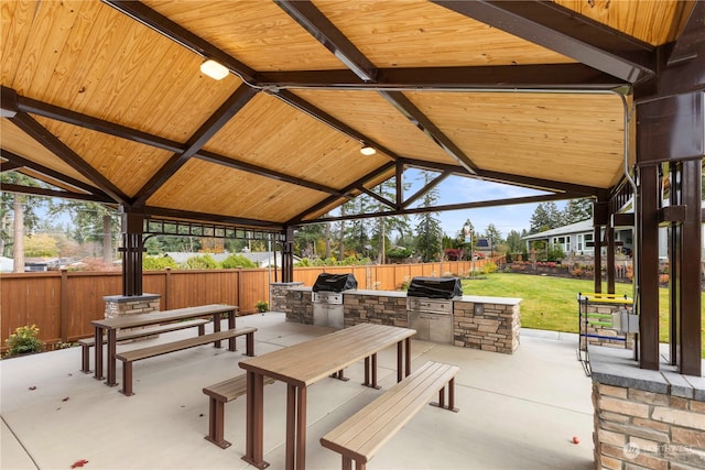 view of patio / terrace with grilling area, an outdoor kitchen, and a gazebo