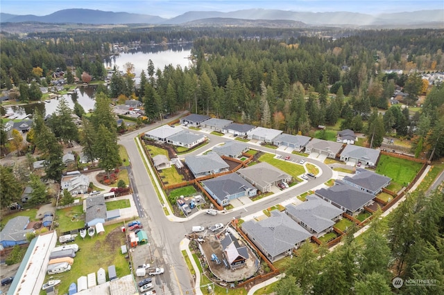 drone / aerial view featuring a water and mountain view