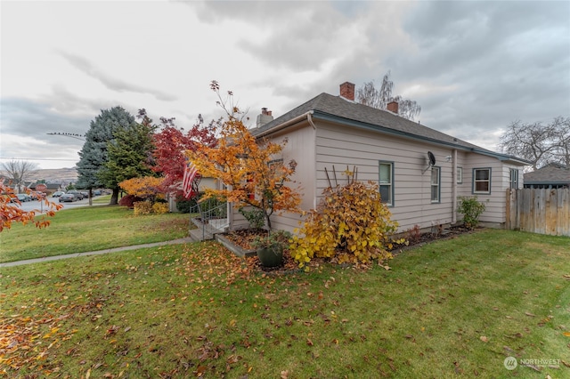 view of side of property featuring a yard