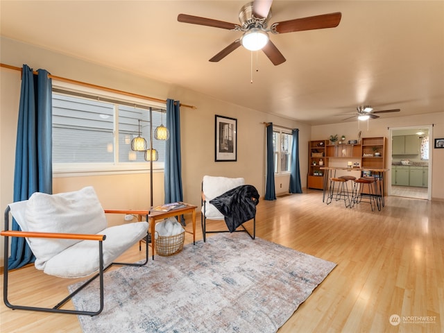 sitting room featuring ceiling fan and light wood-type flooring