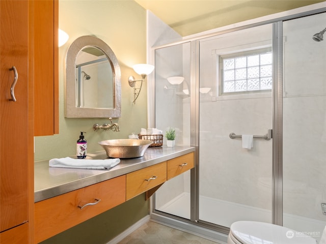 bathroom with vanity, toilet, and an enclosed shower