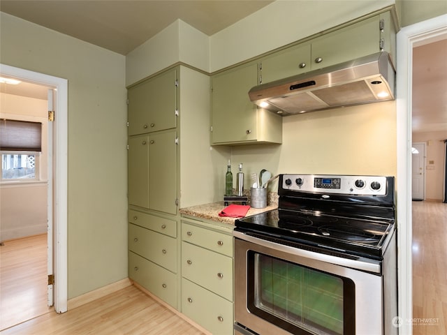 kitchen featuring electric range and light hardwood / wood-style flooring