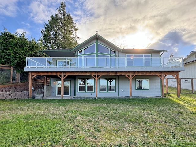 rear view of house with a yard and a deck