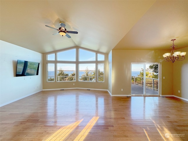 unfurnished living room with light wood-type flooring, lofted ceiling, and ceiling fan with notable chandelier