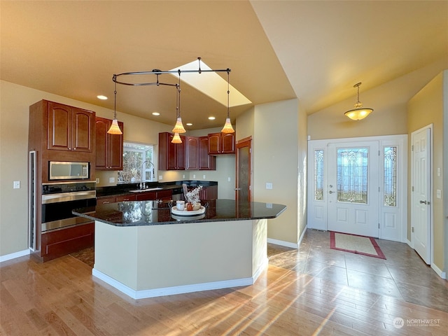 kitchen featuring a center island, appliances with stainless steel finishes, light hardwood / wood-style floors, and plenty of natural light