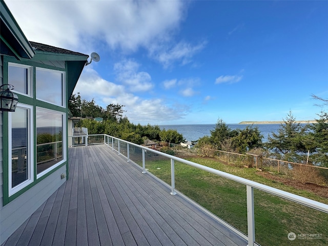 deck with a yard and a water view