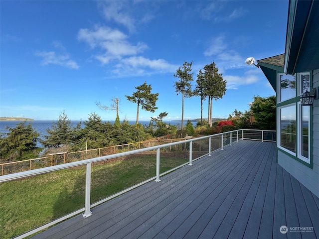 wooden deck with a water view and a yard