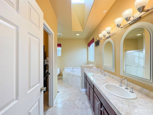 bathroom featuring vanity, tiled tub, and tile patterned floors