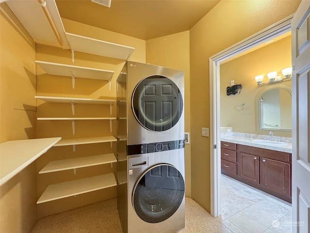 washroom featuring sink and stacked washer and clothes dryer