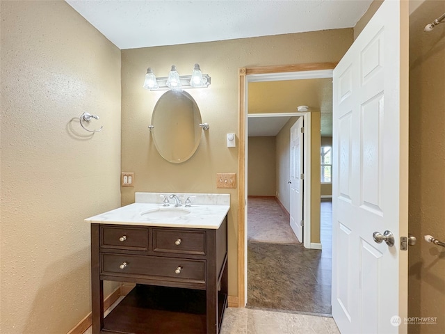 bathroom featuring tile patterned flooring and vanity