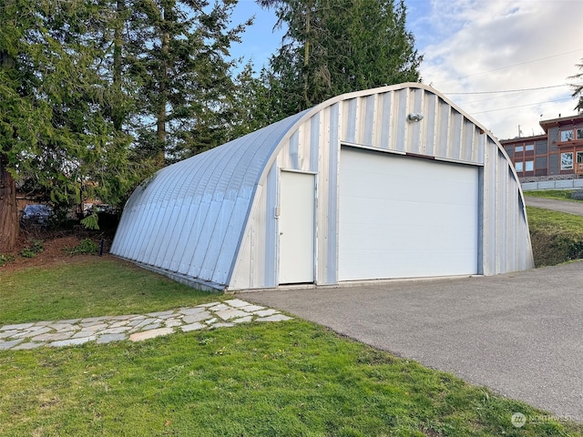 garage featuring a lawn