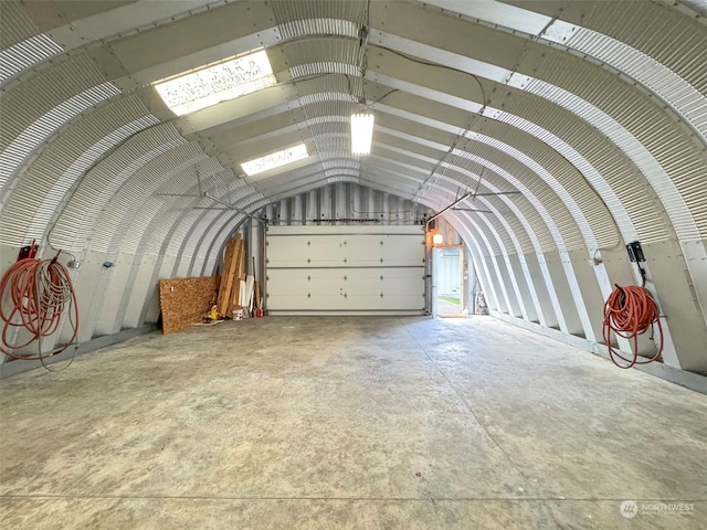 miscellaneous room with lofted ceiling and concrete floors