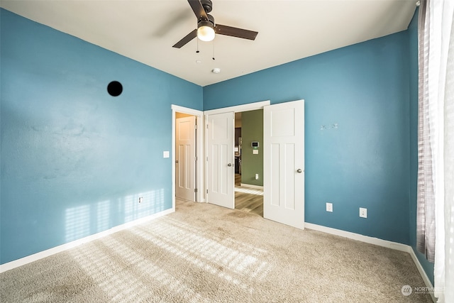 unfurnished bedroom with carpet flooring and ceiling fan