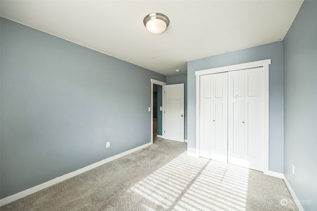 unfurnished bedroom featuring carpet flooring and a closet