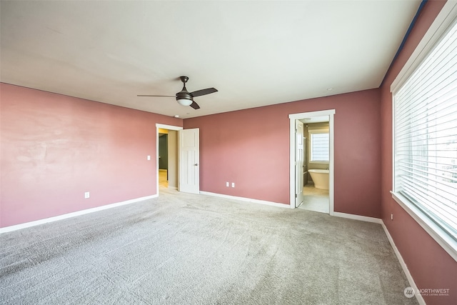 empty room featuring light carpet and ceiling fan