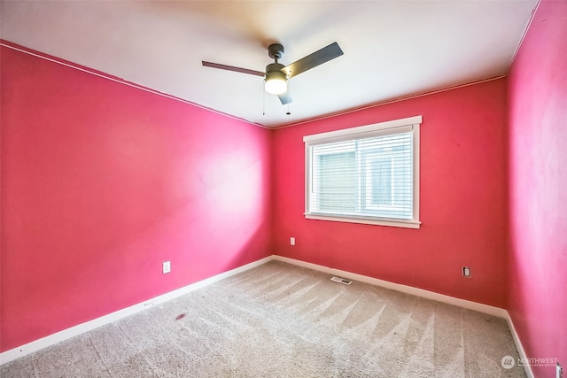 empty room featuring ceiling fan and carpet floors