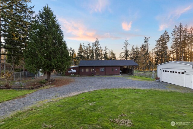 view of front facade featuring a yard, a garage, and an outdoor structure