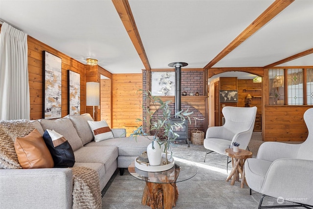 288 Torrence Ln, Oak Harbor, WA 98277 - carpeted living area with a wood stove, wooden walls, and beamed ceiling