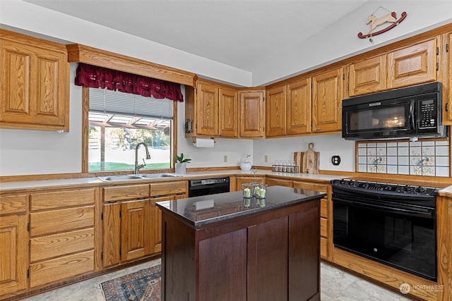 kitchen with black appliances, a kitchen island, and sink