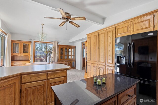 kitchen featuring black refrigerator with ice dispenser, ceiling fan with notable chandelier, light colored carpet, lofted ceiling with beams, and a center island