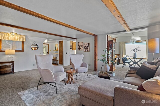 carpeted living room with beam ceiling and a textured ceiling