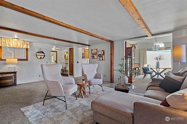 288 Torrence Ln, Oak Harbor, WA 98277 - carpeted living room with beamed ceiling, a chandelier, and a textured ceiling