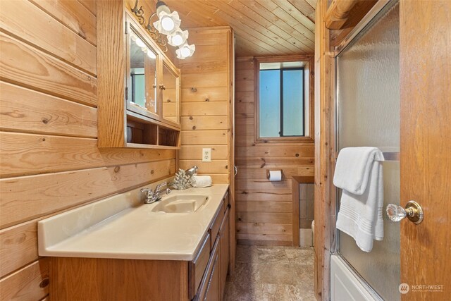 bathroom featuring vanity, enclosed tub / shower combo, wood walls, and wood ceiling