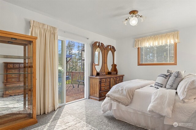 bedroom with carpet floors and access to outside