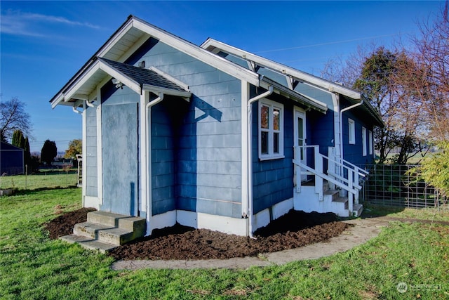 view of side of property featuring a yard