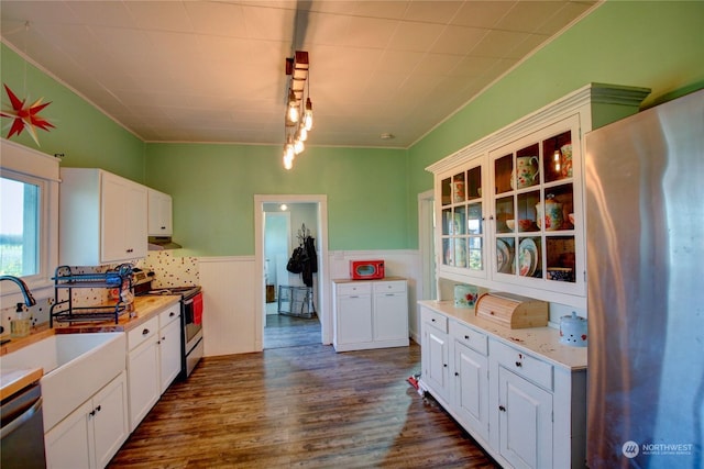 kitchen featuring dark hardwood / wood-style flooring, white cabinetry, sink, and appliances with stainless steel finishes