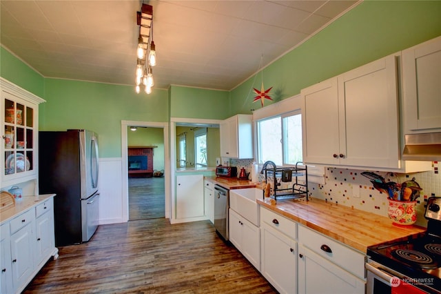 kitchen featuring wood counters, white cabinetry, and appliances with stainless steel finishes