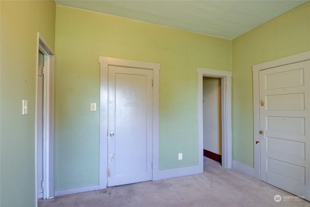 unfurnished bedroom with light colored carpet