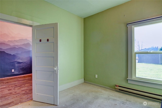 spare room with light hardwood / wood-style flooring and a baseboard heating unit