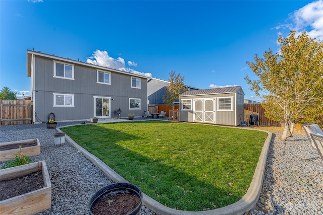 rear view of house with a patio area, a yard, and a storage unit