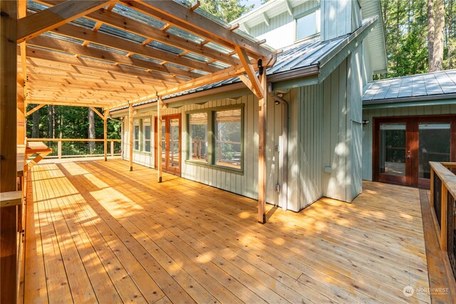 wooden deck featuring french doors and a pergola