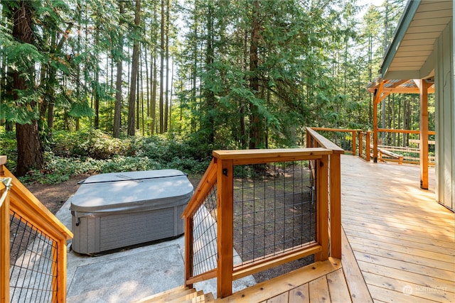 wooden terrace featuring a hot tub