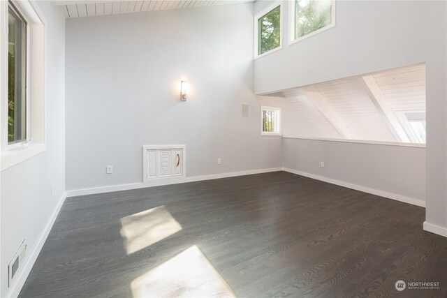 unfurnished living room with lofted ceiling with beams, wood ceiling, and a healthy amount of sunlight