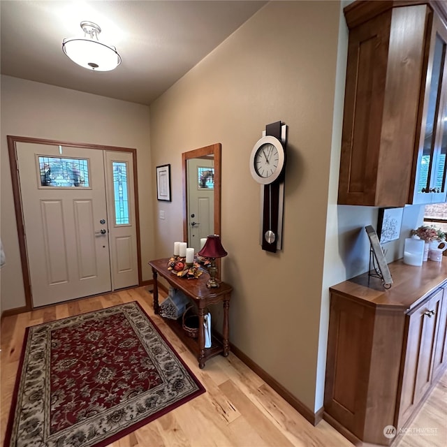 foyer entrance with light hardwood / wood-style floors