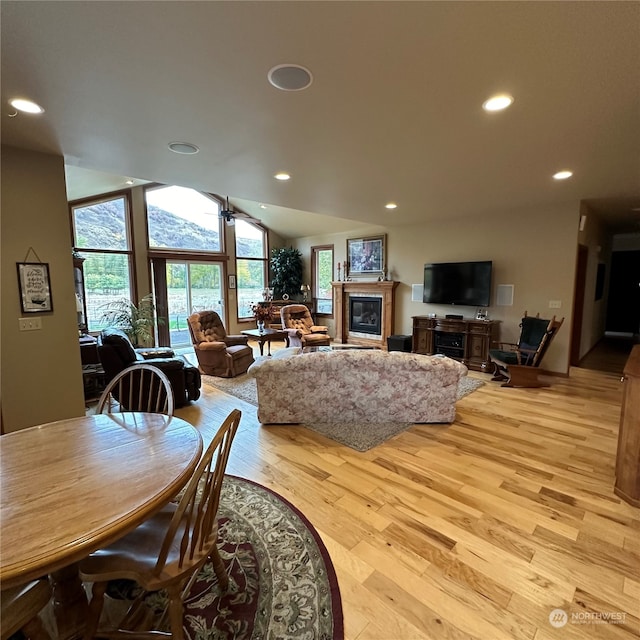 dining room featuring lofted ceiling and light wood-type flooring