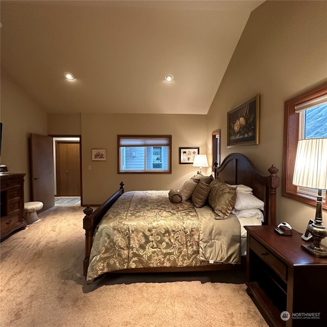 bedroom featuring light colored carpet and vaulted ceiling