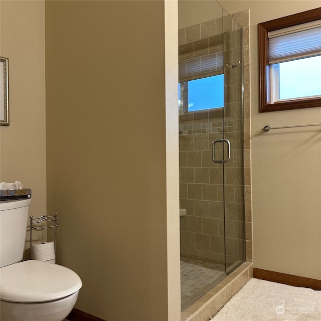 bathroom featuring toilet and walk in shower