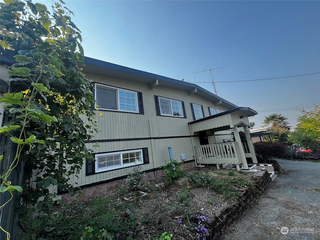 view of side of property with covered porch