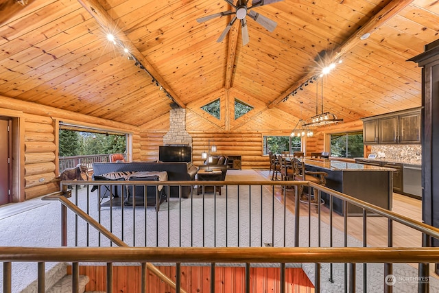 living room featuring wooden ceiling, rustic walls, beam ceiling, and high vaulted ceiling