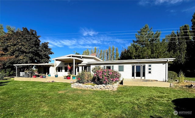 rear view of house featuring a patio and a lawn