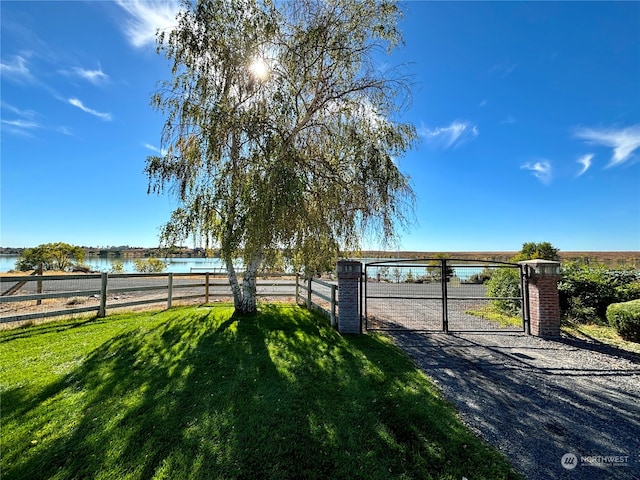 exterior space featuring a water view and a yard